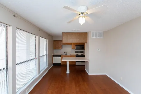 a view of a kitchen with a sink and a refrigerator