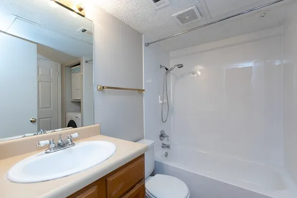 a bathroom with a sink toilet tub and shower