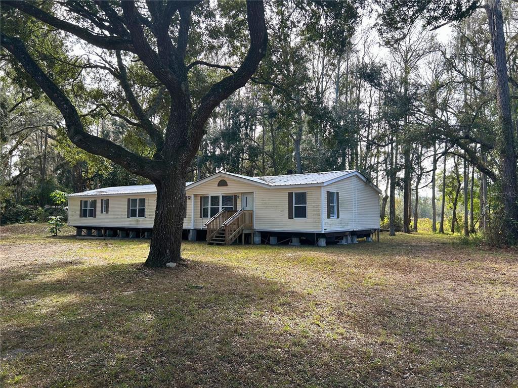 9867 Jerome Drive New Port Richey, FL 34654 - Photo 4 of 30 a front view of a house with garden
