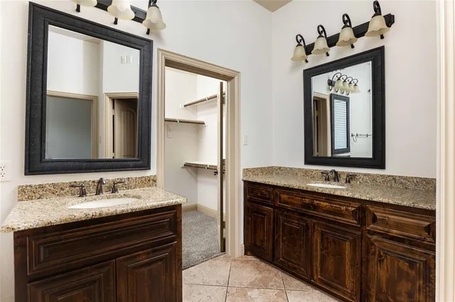 a bathroom with a sink vanity and a mirror