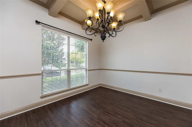 a view of a room with wooden floor and large window