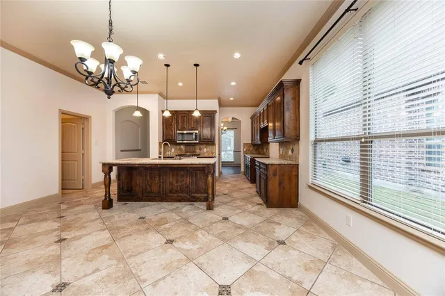 a view of a kitchen with a sink and refrigerator