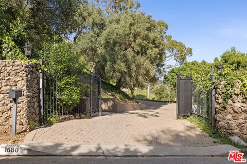 a view of a backyard with large trees