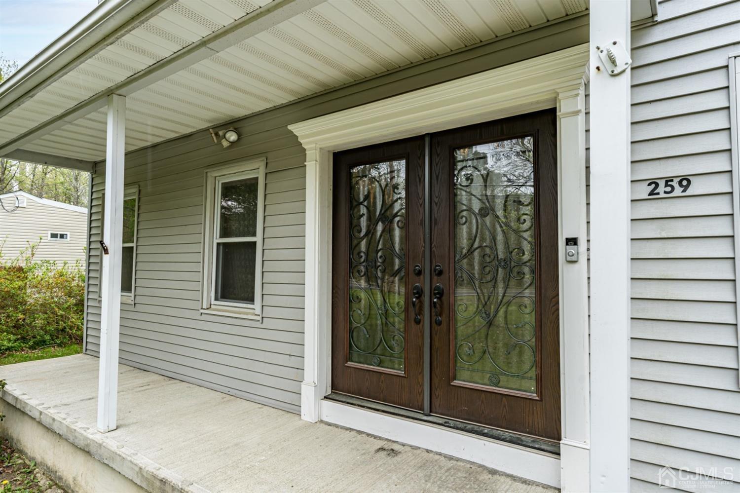 259 Spring Valley Road Morganville, NJ 07751 - Photo 2 of 36 a view of a porch with a door and a porch
