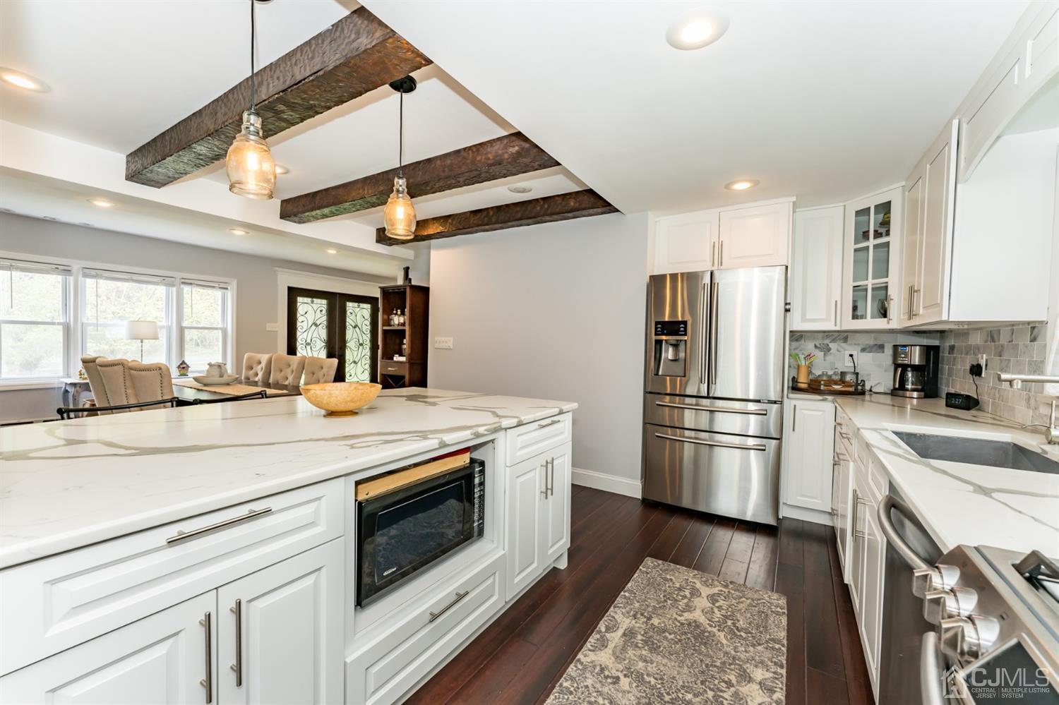 259 Spring Valley Road Morganville, NJ 07751 - Photo 13 of 36 a kitchen with a stove sink and refrigerator