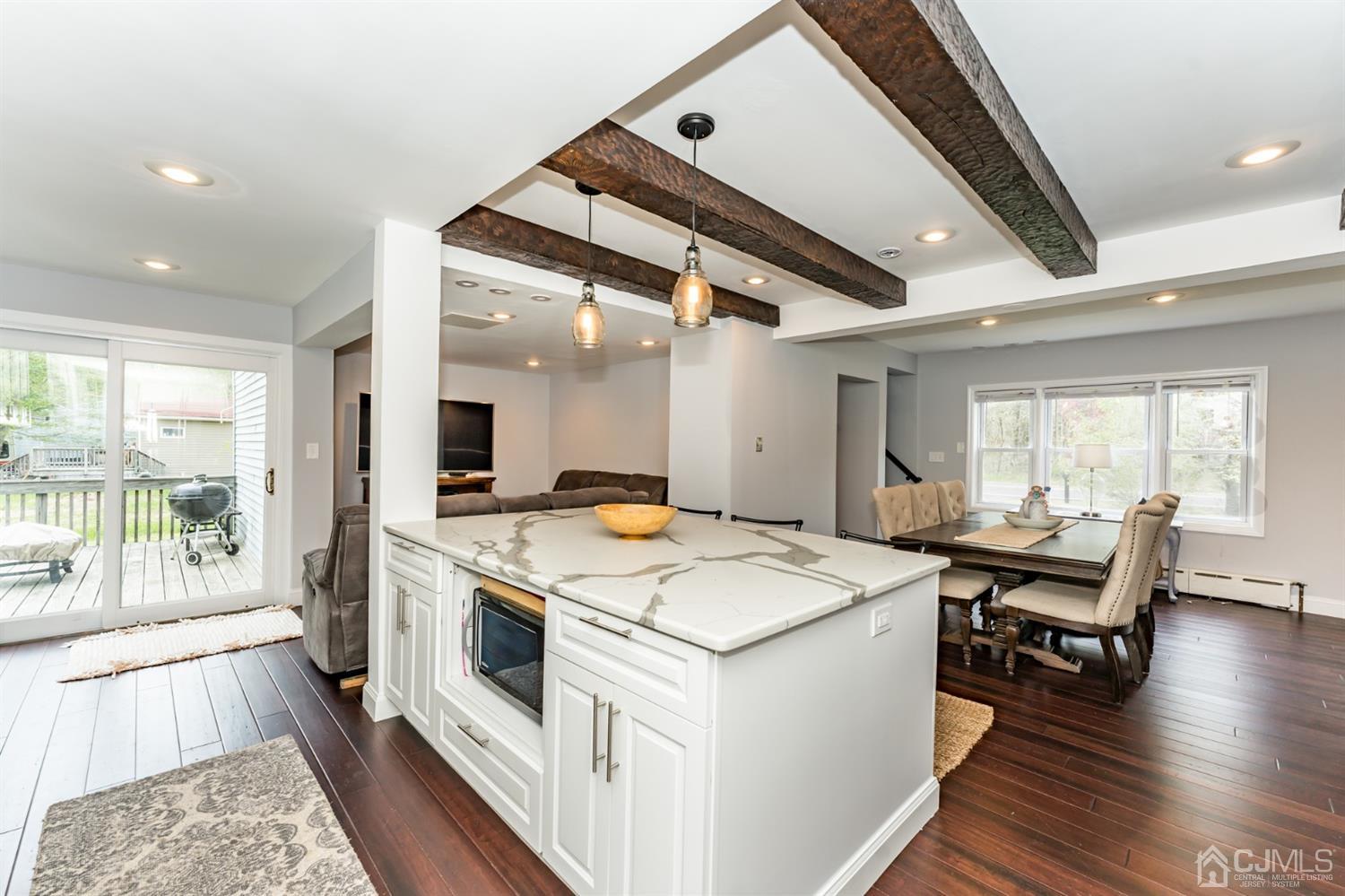 259 Spring Valley Road Morganville, NJ 07751 - Photo 14 of 36 a kitchen with a stove and wooden floor