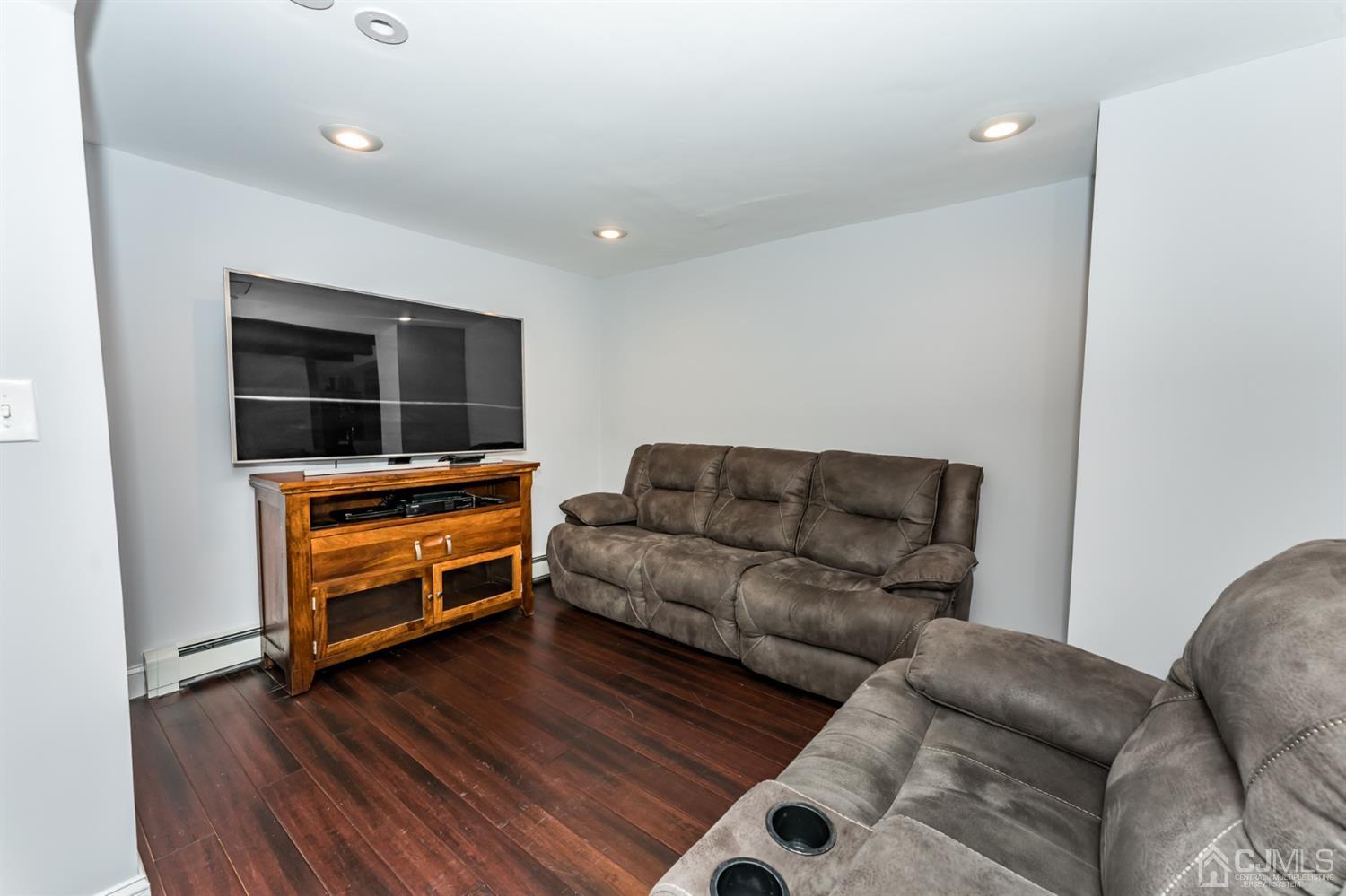 259 Spring Valley Road Morganville, NJ 07751 - Photo 15 of 36 a living room with furniture and wooden floor