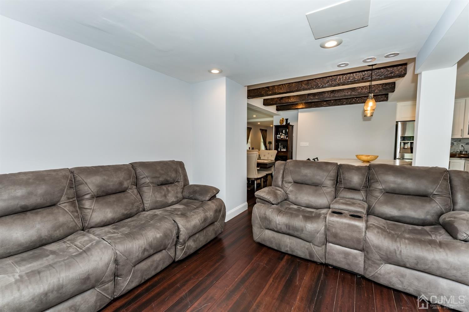 259 Spring Valley Road Morganville, NJ 07751 - Photo 16 of 36 a living room with furniture and a wooden floor