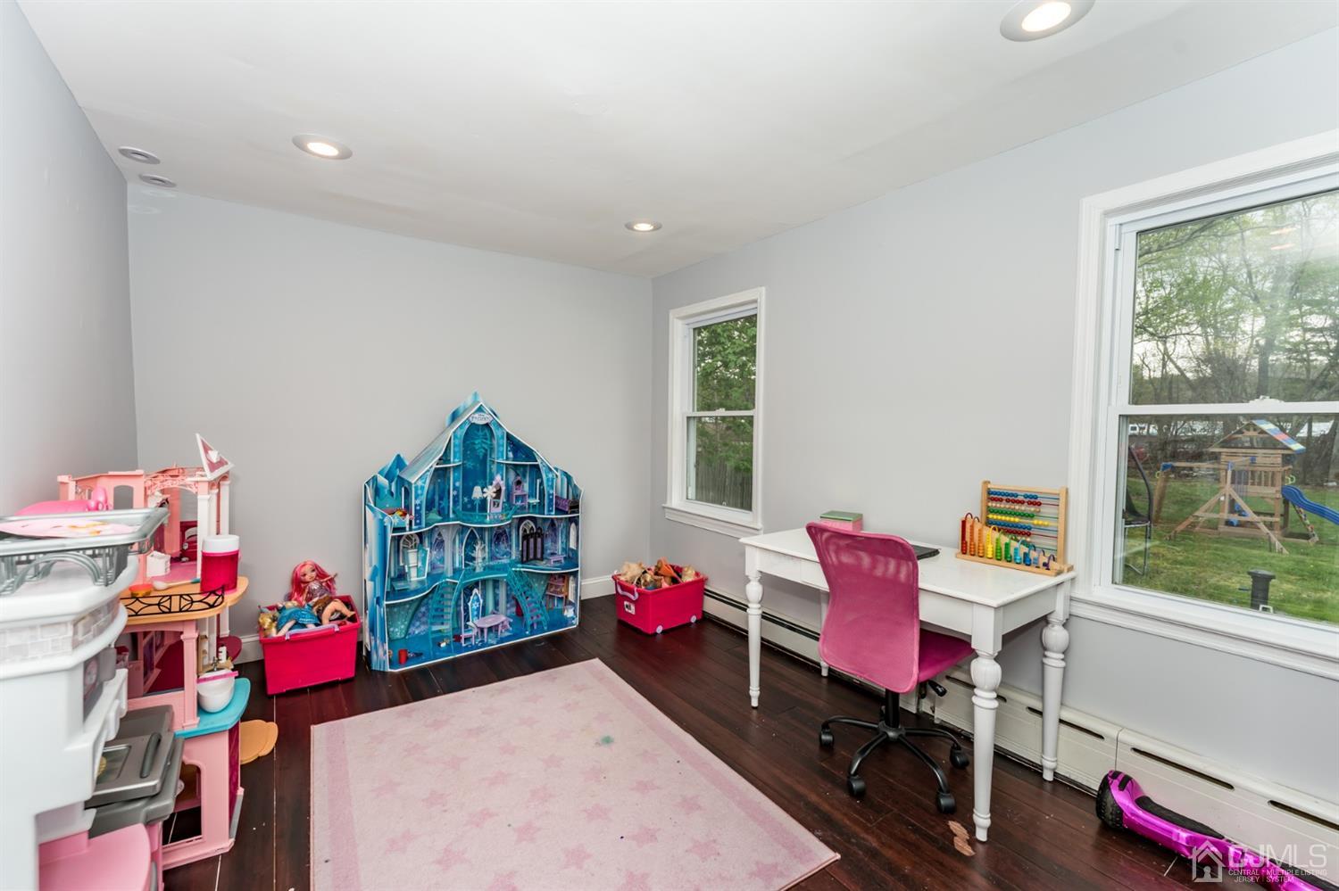 259 Spring Valley Road Morganville, NJ 07751 - Photo 18 of 36 a bedroom with furniture a rug toys and a window