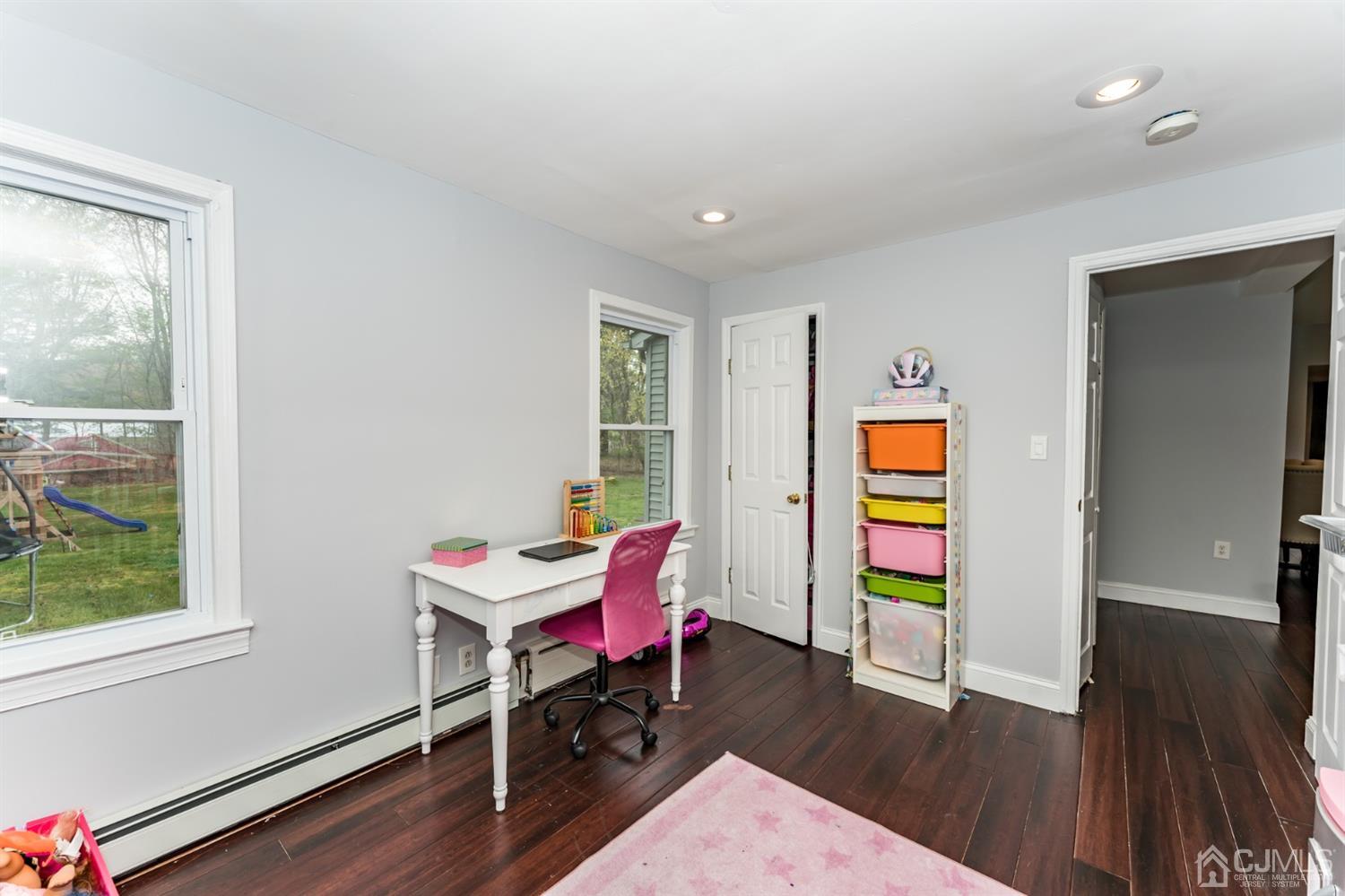 259 Spring Valley Road Morganville, NJ 07751 - Photo 19 of 36 a living room with furniture and a wooden floor