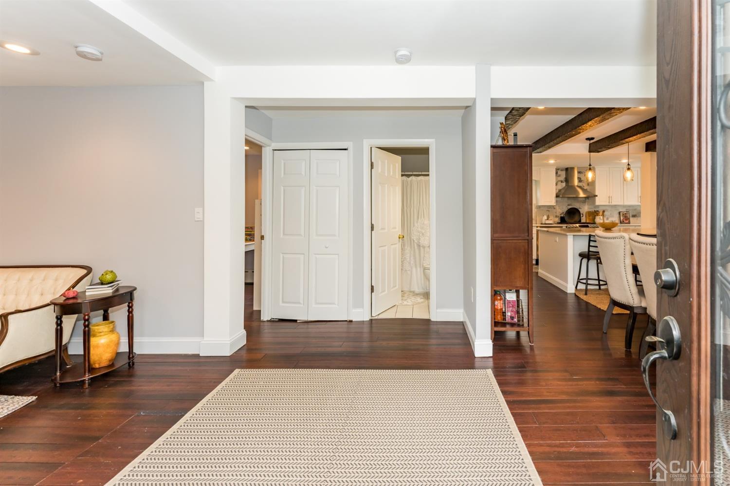 259 Spring Valley Road Morganville, NJ 07751 - Photo 3 of 36 wooden floor in a hall with a rug