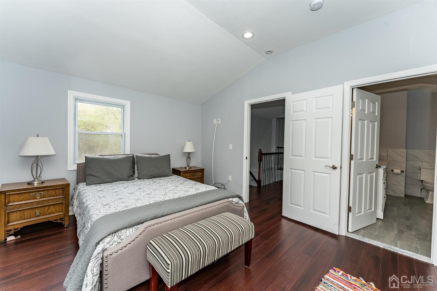 259 Spring Valley Road Morganville, NJ 07751 - Photo 22 of 36 a bedroom with a bed and a lamp