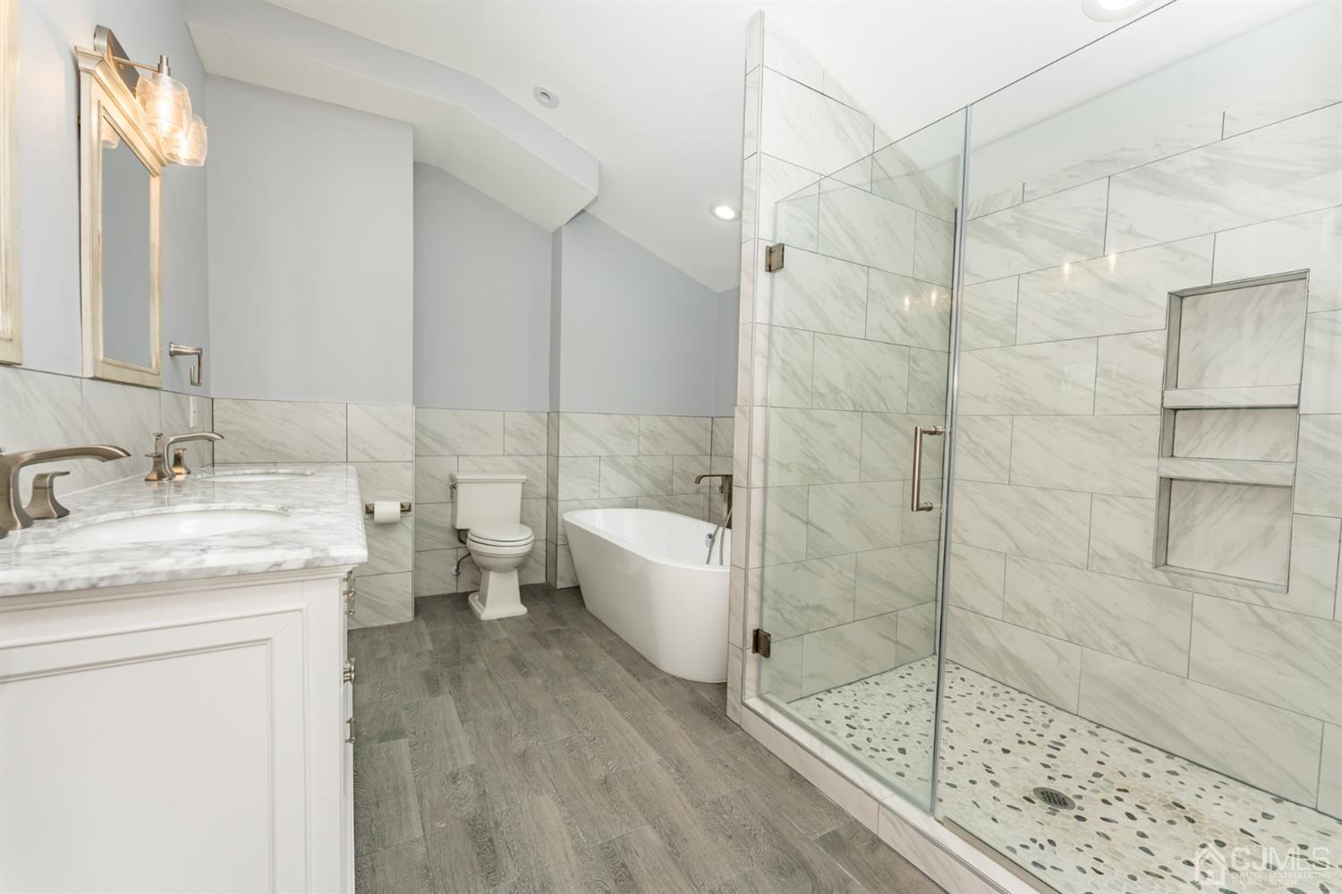 259 Spring Valley Road Morganville, NJ 07751 - Photo 24 of 36 a bathroom with a granite countertop sink a toilet and shower