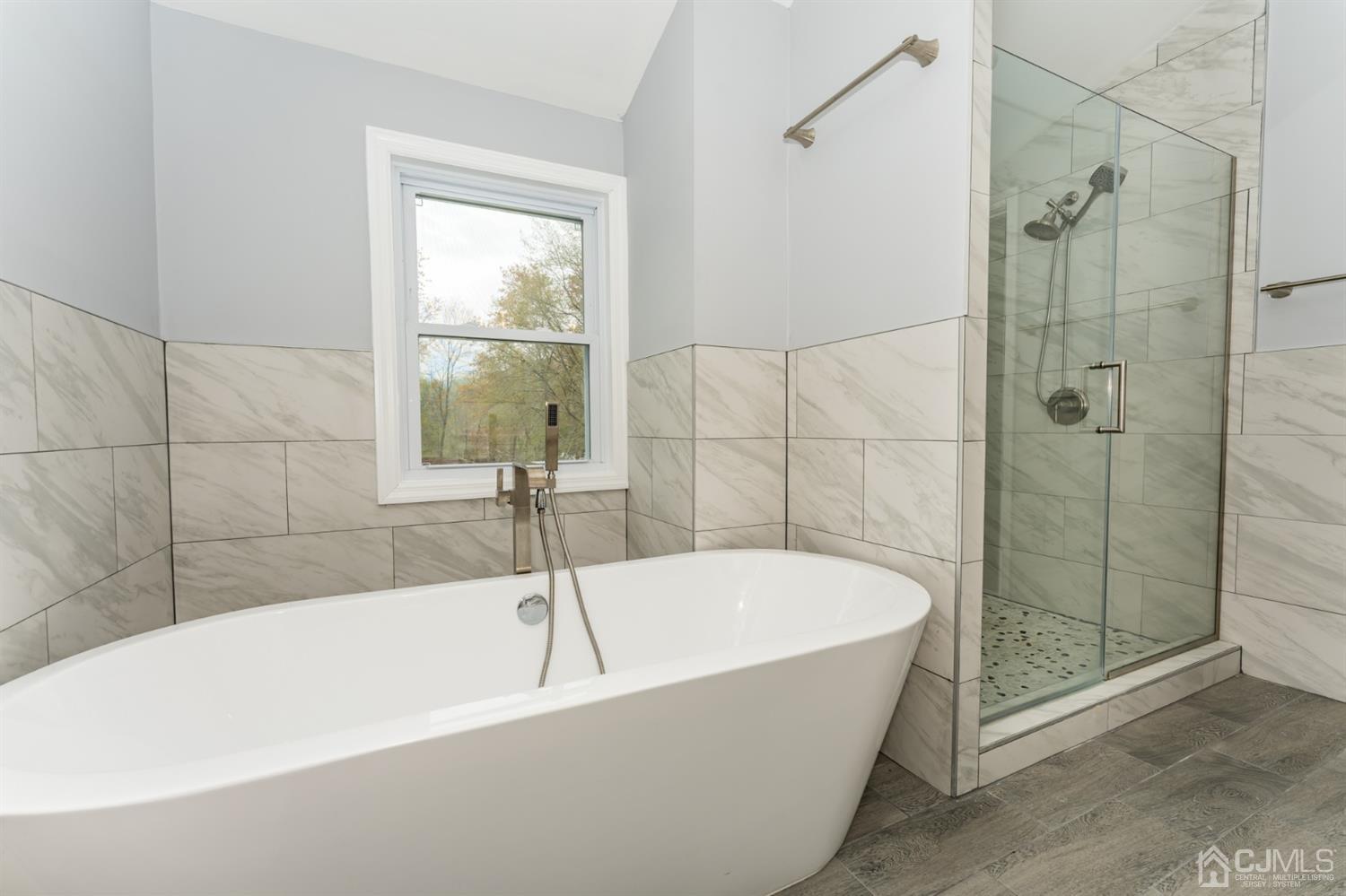 259 Spring Valley Road Morganville, NJ 07751 - Photo 25 of 36 a white bath tub sitting next to a shower