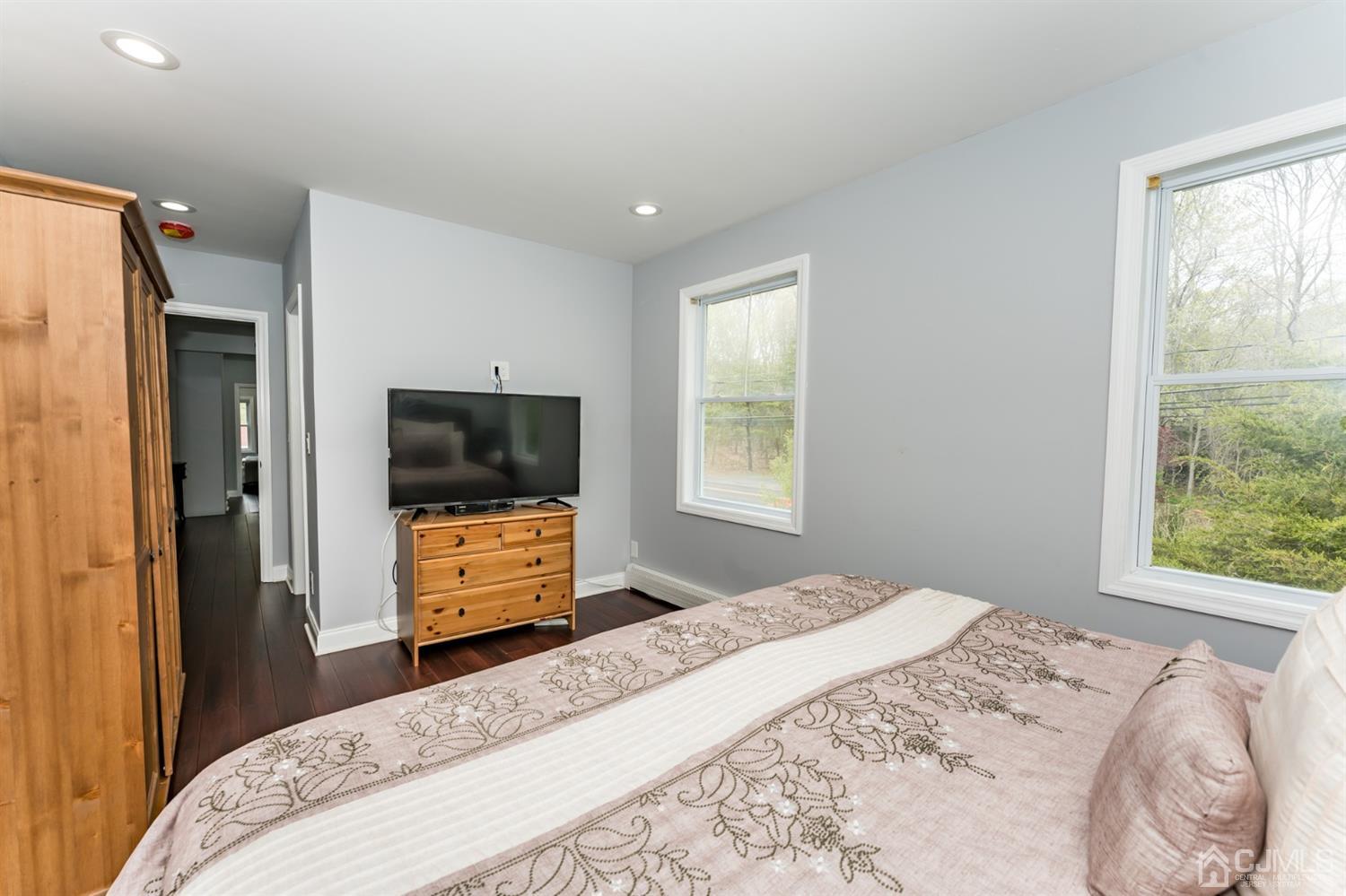 259 Spring Valley Road Morganville, NJ 07751 - Photo 27 of 36 a bedroom with a bed and a flat screen tv