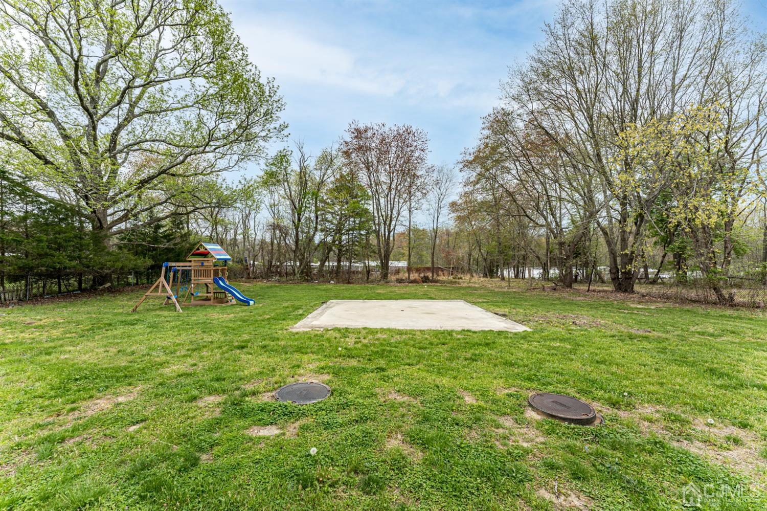 259 Spring Valley Road Morganville, NJ 07751 - Photo 33 of 36 a swimming pool with outdoor seating and yard