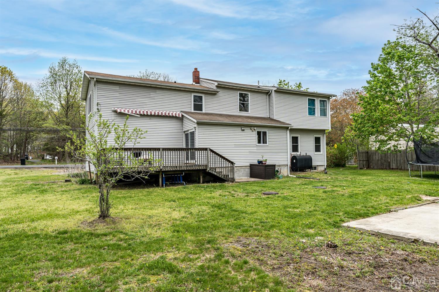 259 Spring Valley Road Morganville, NJ 07751 - Photo 36 of 36 a view of a house with a yard and sitting area