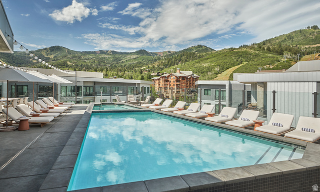 2417 West High Road, Unit 3210 Park City, UT 84098 - Photo 33 of 44 Outdoor pool and lounge deck at Pendry Park City with Park City Mountain ski terrain as the backdrop.