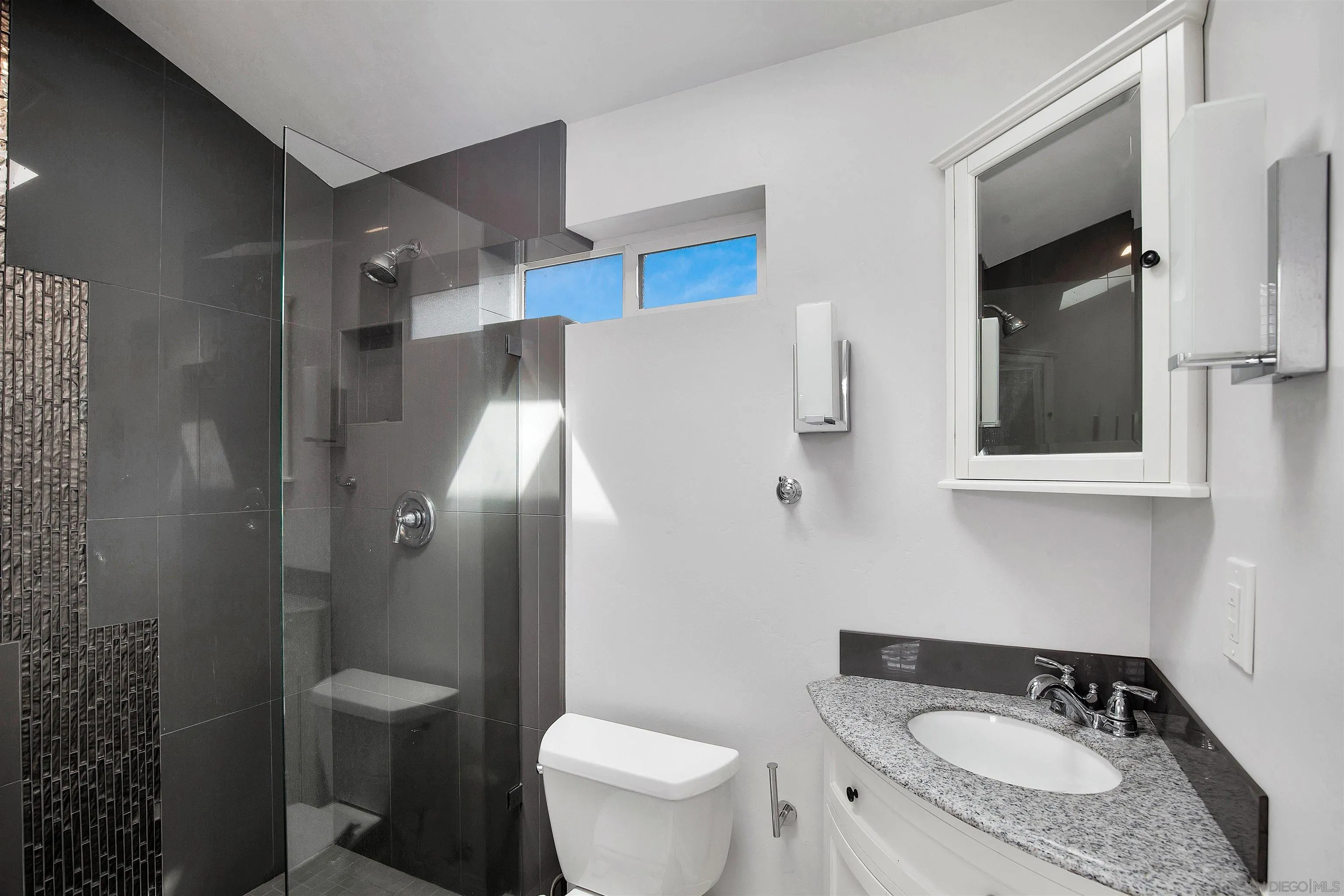 415 Marview Drive Solana Beach, CA 92075 - Photo 39 of 53 a bathroom with a granite countertop sink toilet and a mirror