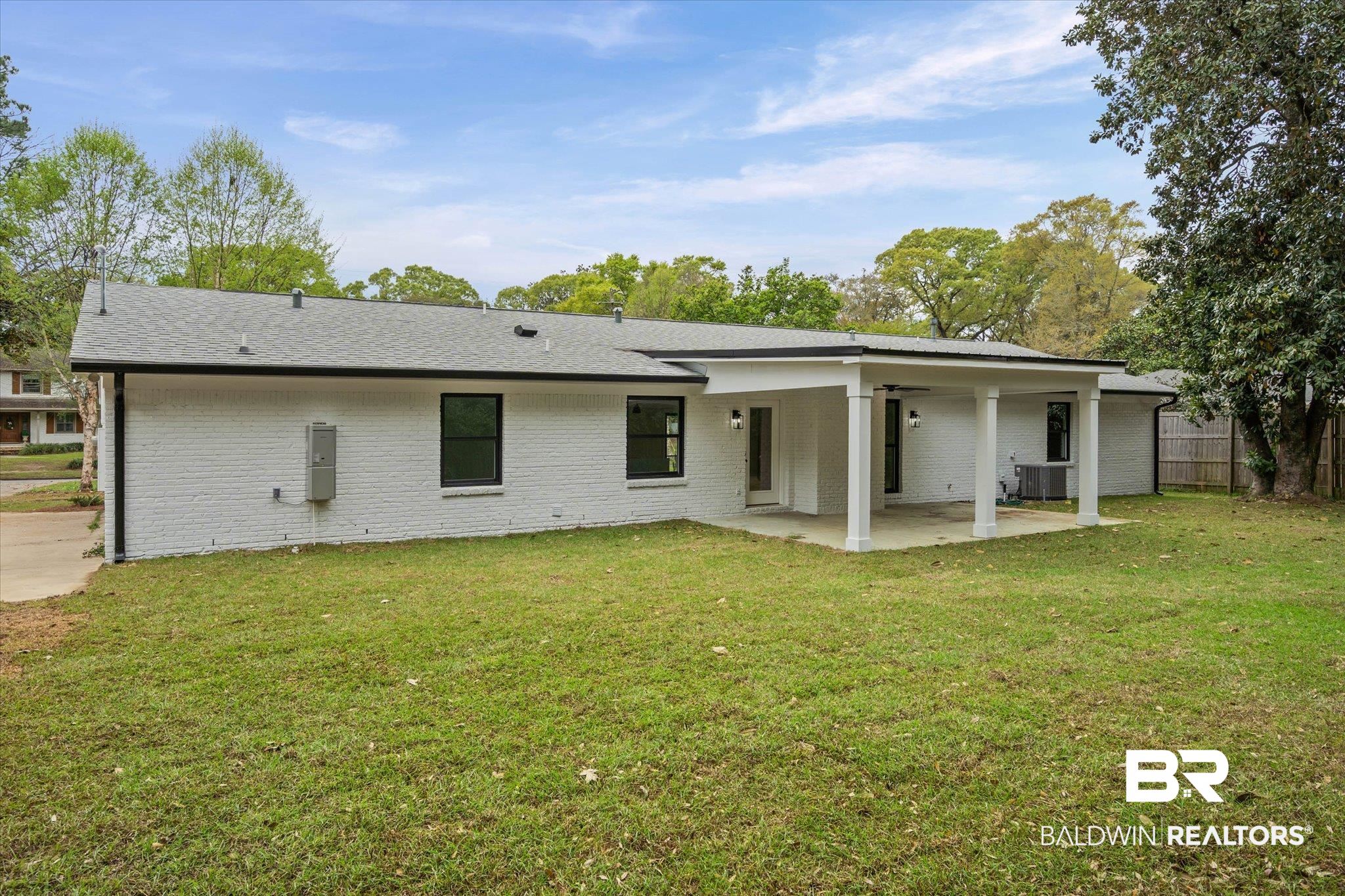 11 Schwaemmle Drive Mobile, AL 36608 - Photo 29 of 32 Rear view of house with a lawn, brick siding, a patio, and roof with shingles
