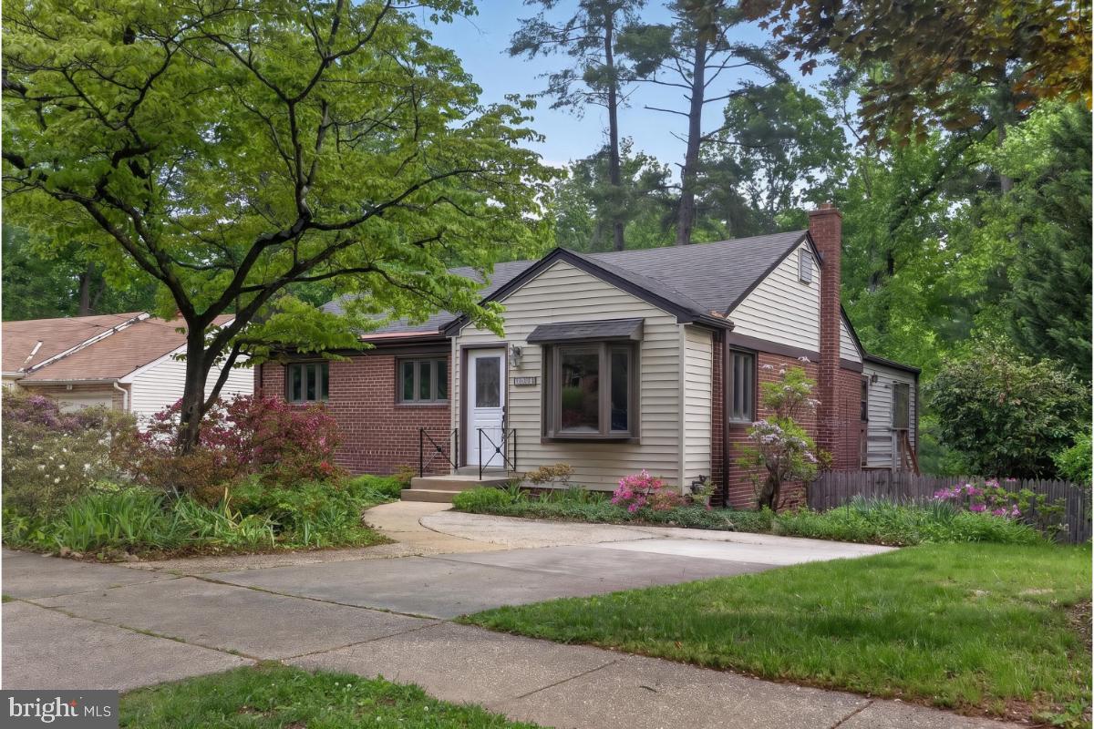 4068 Adams Drive Silver Spring, MD 20902 - Photo 43 of 43 a front view of a house with a yard and garage