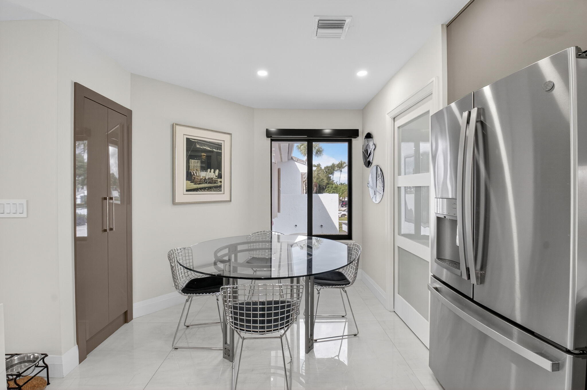 15846 Loch Maree Lane, Unit 2904 Delray Beach, FL 33446 - Photo 15 of 60 a dining room with stainless steel appliances a dining table and chairs