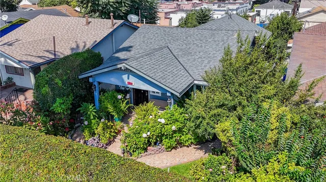 an aerial view of a house with a yard and potted plants