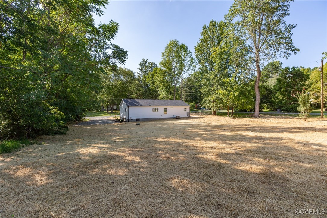 64 Pine Road Louisa, VA 23093 - Photo 42 of 45 a backyard of a house with trees and outdoor space
