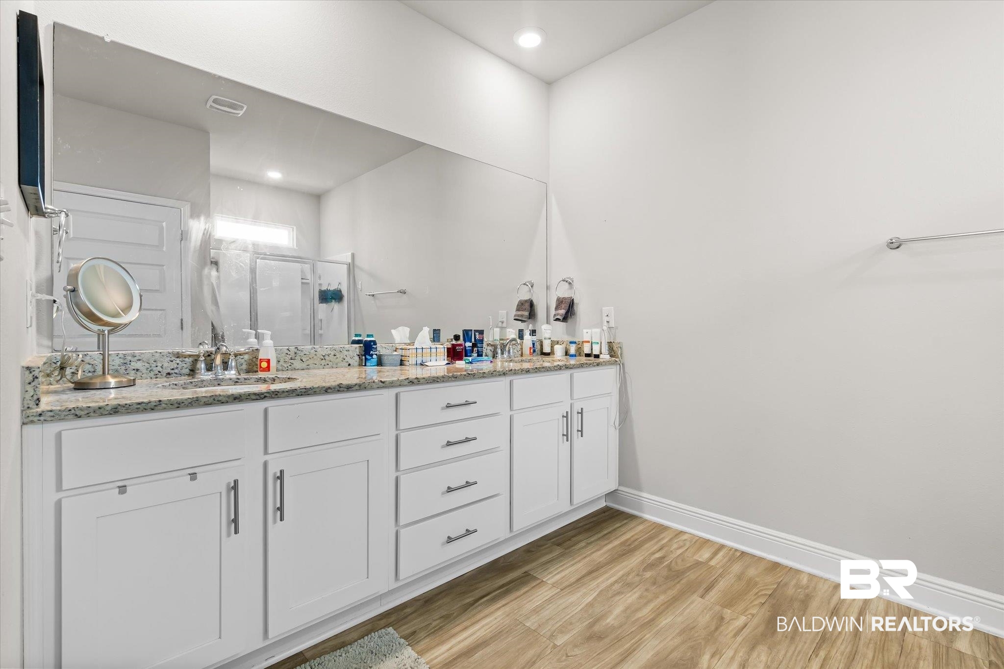 24262 Alydar Loop Daphne, AL 36526 - Photo 10 of 33 Bathroom with double vanity, a stall shower, a sink, wood finished floors, and baseboards