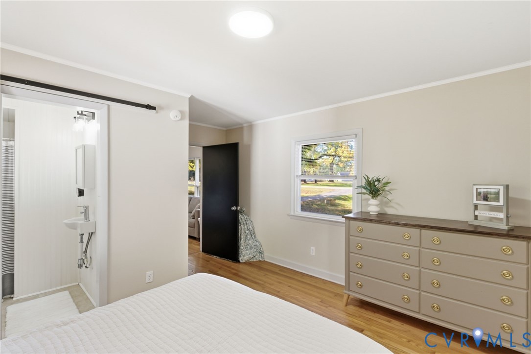 8456 Atlee Road Mechanicsville, VA 23116 - Photo 13 of 28 a bedroom with a bed and a dresser in it