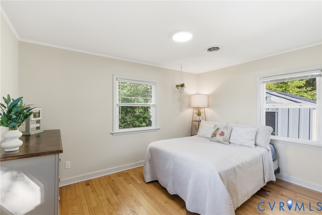8456 Atlee Road Mechanicsville, VA 23116 - Photo 14 of 28 a bedroom with a bed and a potted plant
