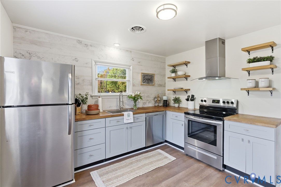 8456 Atlee Road Mechanicsville, VA 23116 - Photo 7 of 28 a kitchen with white cabinets and white appliances