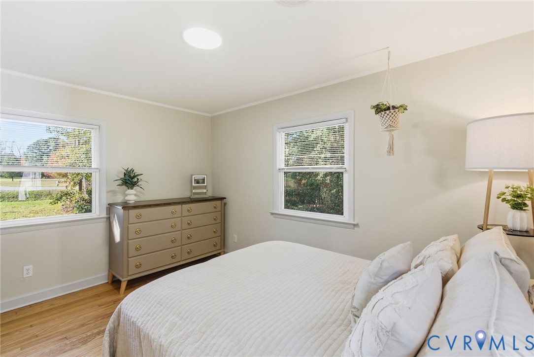 8456 Atlee Road Mechanicsville, VA 23116 - Photo 10 of 28 a bedroom with a bed and wooden floor