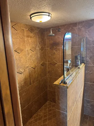 a bathroom with a toilet and a shower