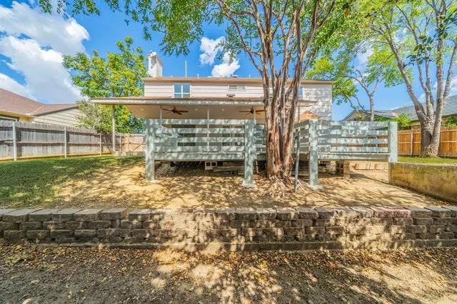 a view of a yard with wooden fence