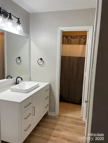 a bedroom with a bed and a night stand