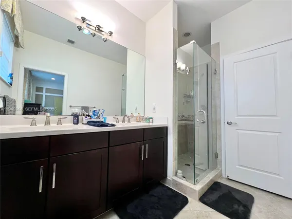 a bathroom with a double vanity sink and mirror