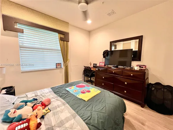 a bedroom with a bed and flat screen tv