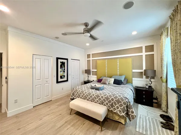 a bedroom with a bed couch and window