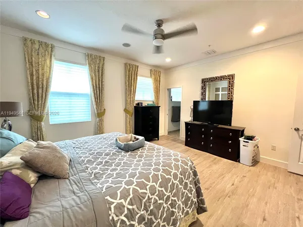 a bedroom with a bed and a flat screen television