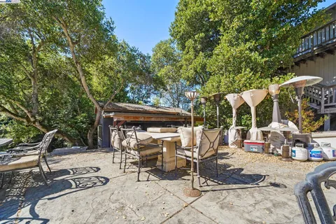 a view of backyard with seating space and trees