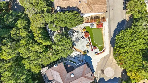 an aerial view of a house with a yard and garden