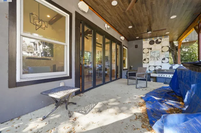 a living room with furniture and a painting on the wall