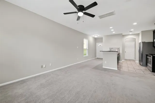 a view of a kitchen with a sink and a ceiling fan