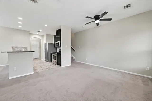 a view of a kitchen with a sink and stainless steel appliances