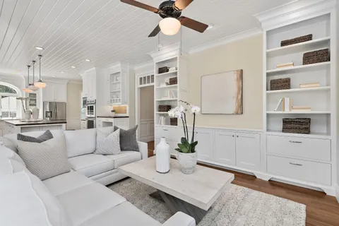 a living room with furniture a rug and white walls