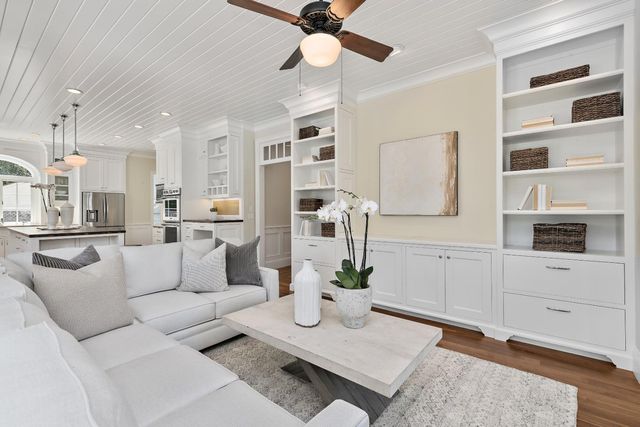 a living room with furniture a rug and white walls