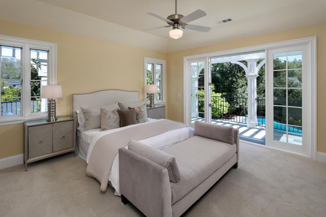 a bedroom with a large bed and a large window