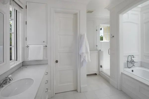 a bathroom with a tub sink and mirror