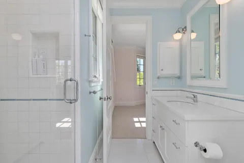 a bathroom with a tub sink and mirror